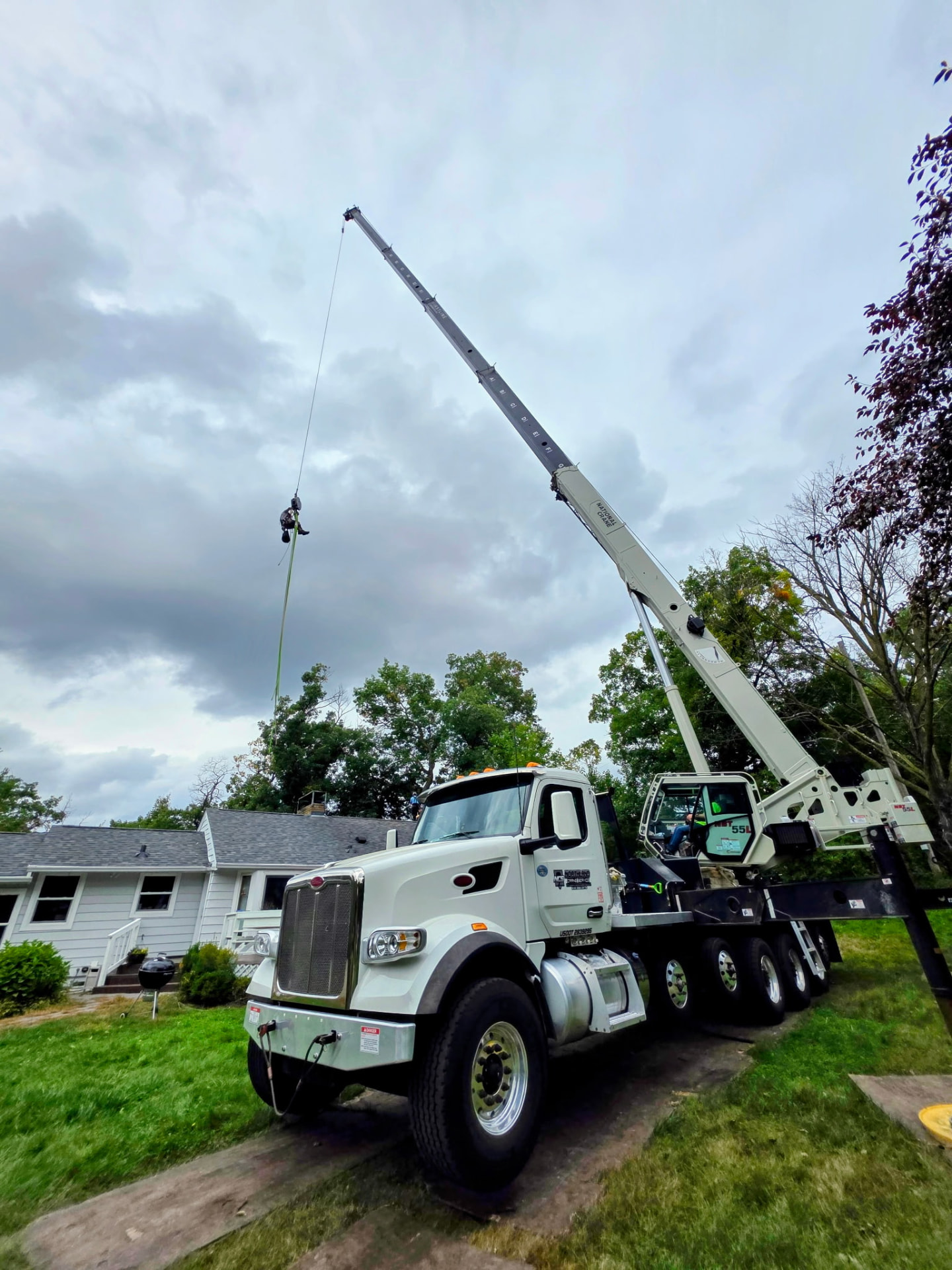 National Crane NBT 55L truck with outriggers set over a West Metro home